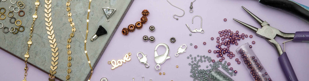 Assortment of jewelry-making supplies including chains, charms, clasps, and more