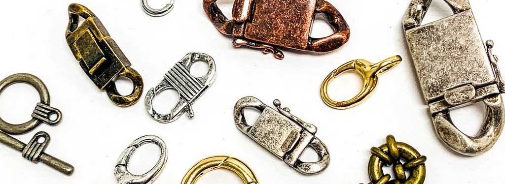 Assorted jewelry clasps including toggles, lobster claws, magnetic clasps, and buckle clasps