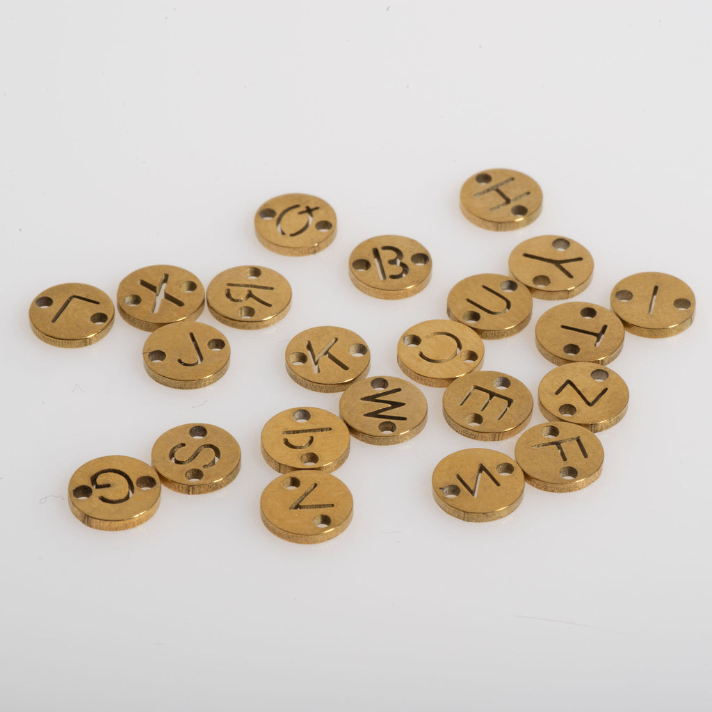 Assorted alphabet charms and connectors for personalized jewelry making